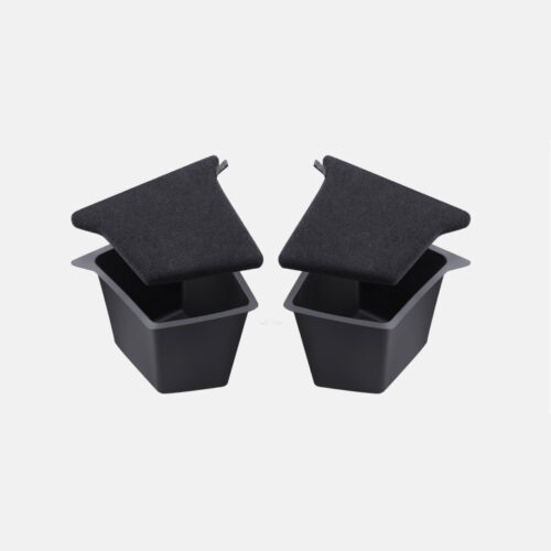 Two small black square trash bins with dark gray fabric lids resting on top.