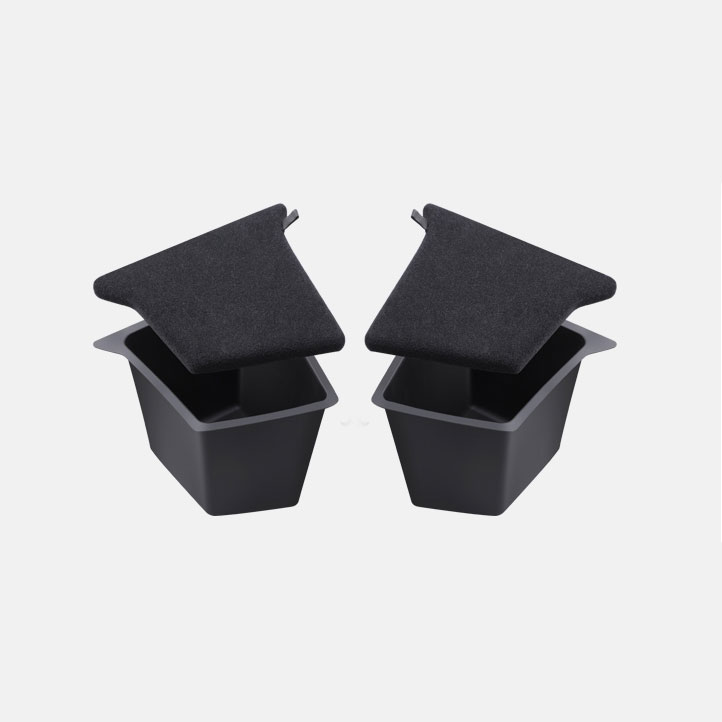 Two small black square trash bins with dark gray fabric lids resting on top.