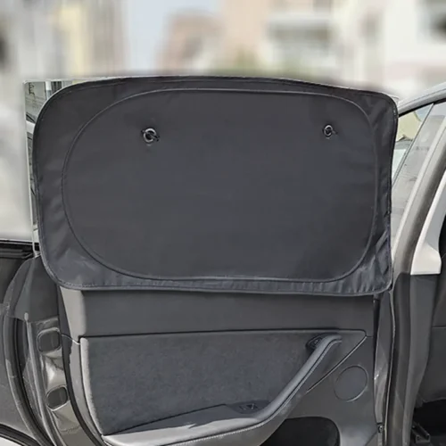 Open car door with a black fabric window shade covering the rear window, obscuring the view outside; interior door panel visible below the shade.