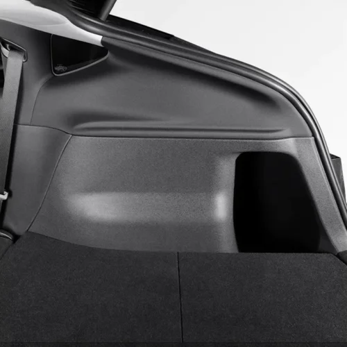 Car trunk/cargo area with a folded rear seat and black carpeted floor
