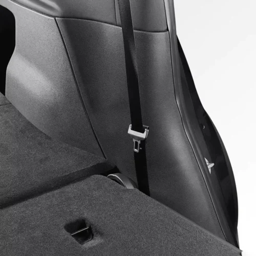 Close-up of a car seat with a black seat belt hanging down and buckle in view.