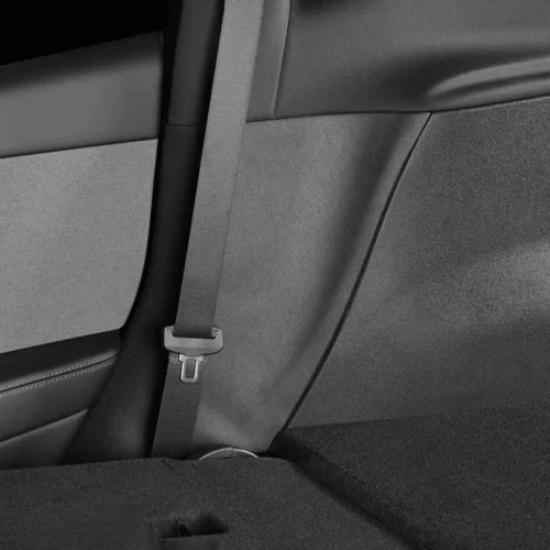 Rear seat belt fastened with buckle visible in a car’s back seat.