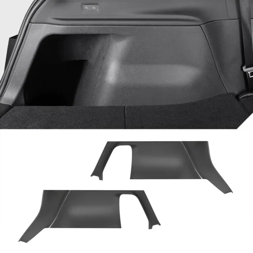 Rear cargo area of a car with two separate plastic trim/fender liner panels laid out nearby