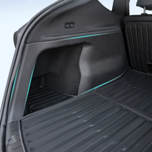 Trunk of an SUV showing a side storage pocket, cargo area mat, and a blue accent light along the side panel.