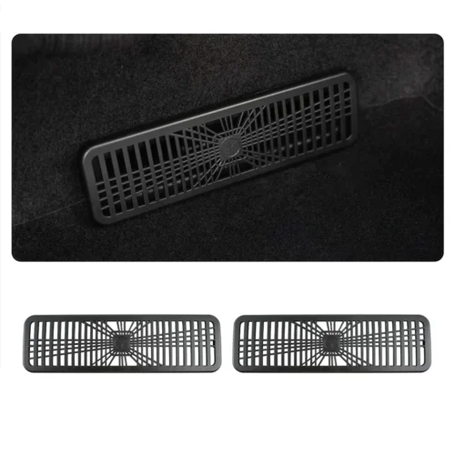 Rectangular ventilation grille with a radial spoke pattern on dark carpet (car floor vent). If used as a product image, indicate a long rectangular vent cover with a central starburst hub and vertical slats.”,