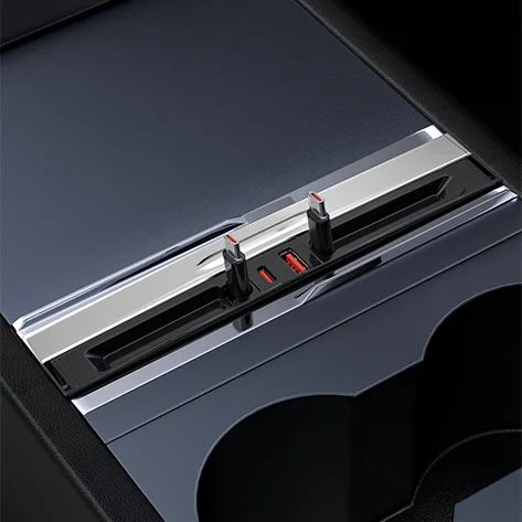 Close-up of a car's center console slot with two red-tipped electrical connectors