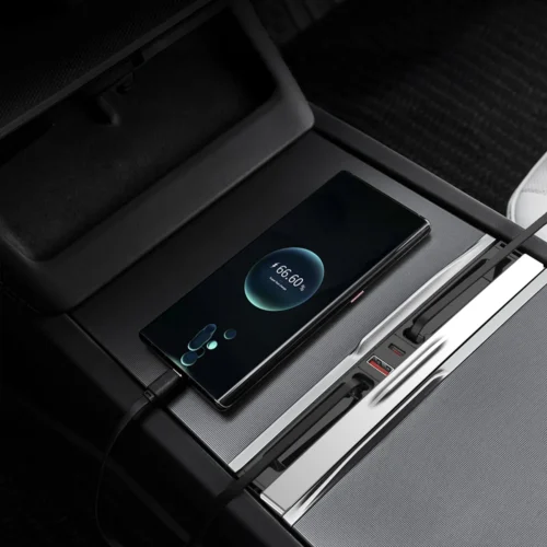 Phone resting in a car's center console charging dock, screen showing 66% battery remaining (charging in progress).