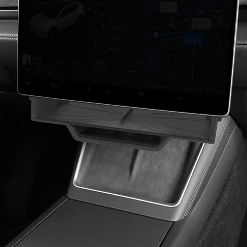 Tablet mounted on the car's center console above a storage tray area.