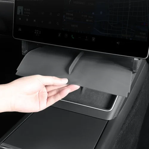 Retractable tray being pulled out from under the car's touchscreen center console by a hand.