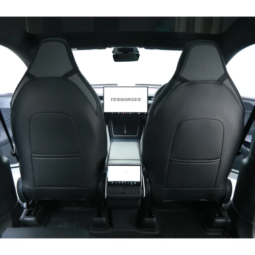 View from the rear seats of a modern car interior with two black leather seats and a central touchscreen displaying 'TESSORIES'.