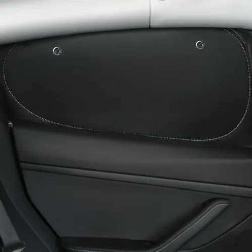 Inside a car door, a large black storage pocket with white dotted stitching along its curved edge.
