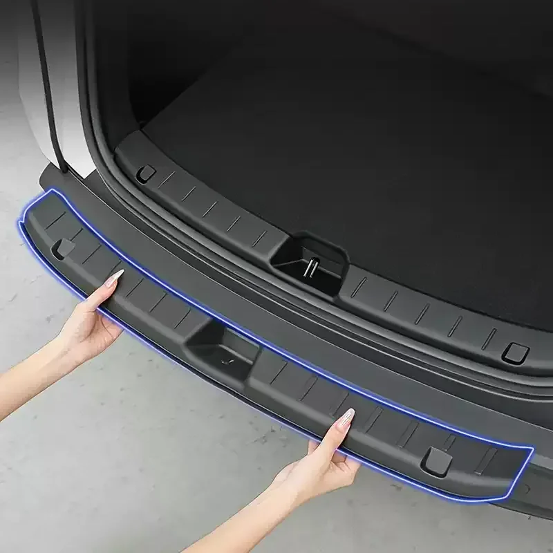 Person installs a curved plastic bumper protector along the open trunk lip of a SUV, blue outline visible for guidance.