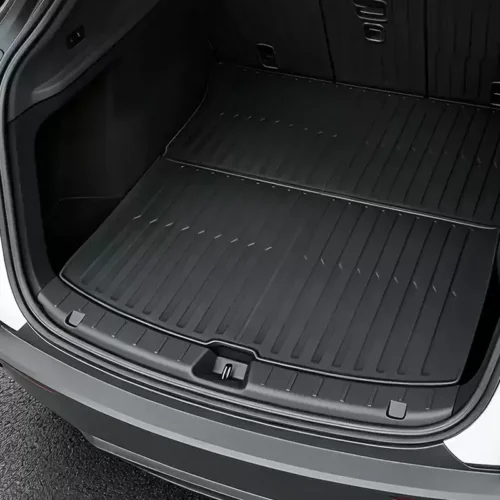 Rear cargo area of an SUV with a large black, ridged all-weather mat covering the floor.