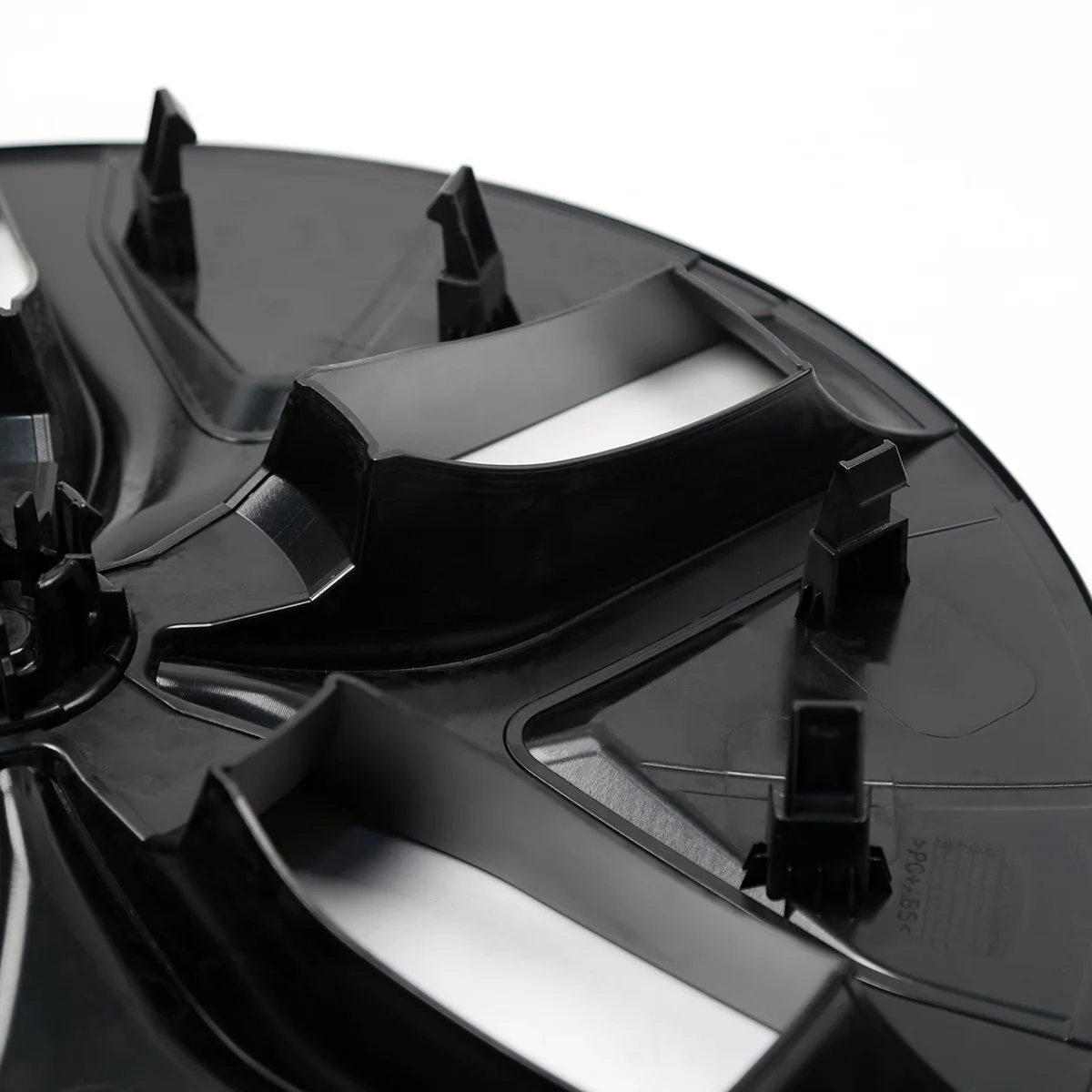 Close-up of a black plastic automotive trim piece with multiple mounting clips.