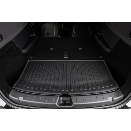 Flat cargo area in a car with rear seats folded down, showing a ribbed rubber mat and expanded storage space.