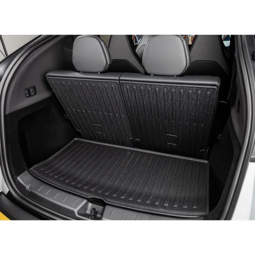 Rear hatch area of a SUV showing the folded seatbacks upright and a textured cargo floor mat for added storage space