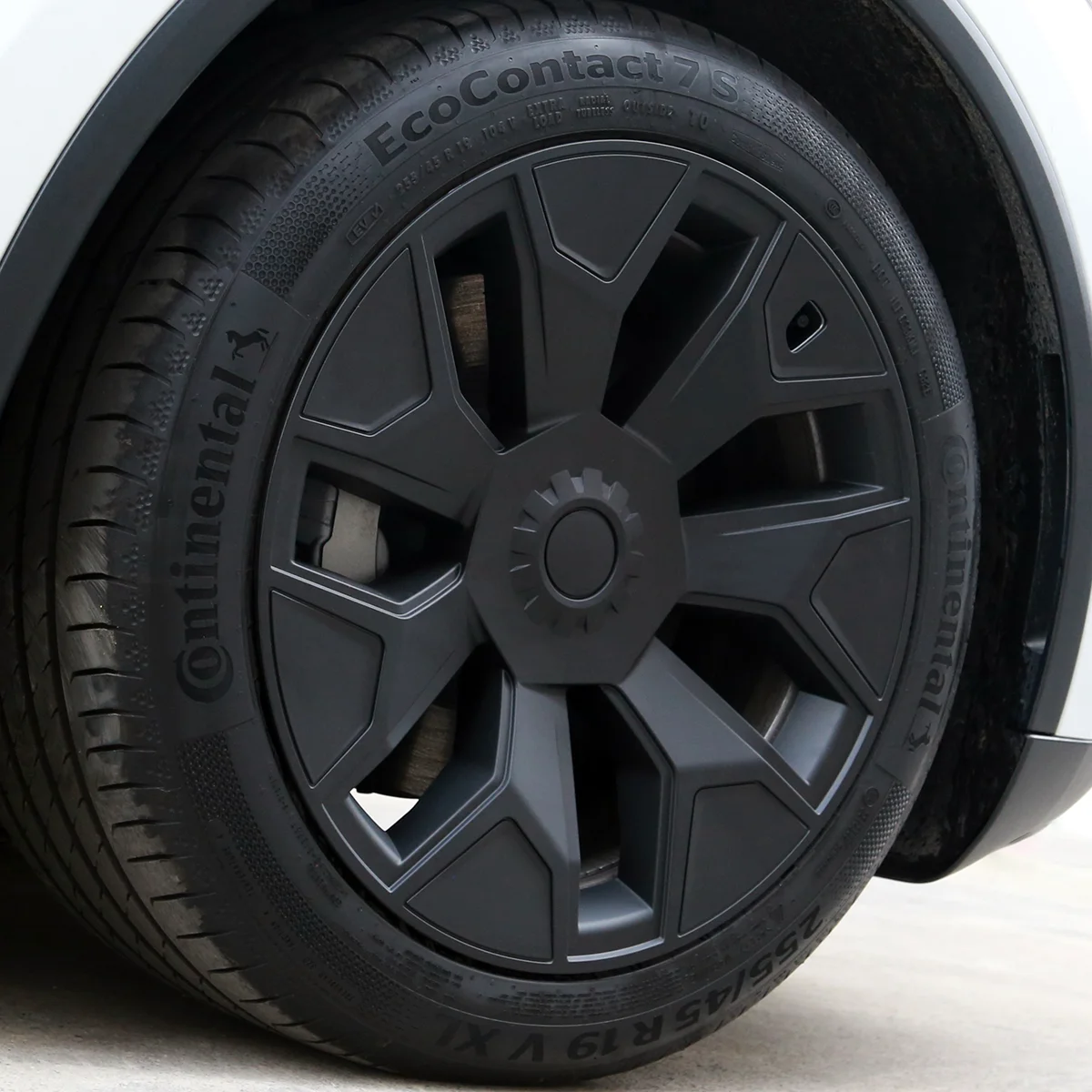 Close-up of a black alloy wheel mounted on a Continental EcoContact 7S tire