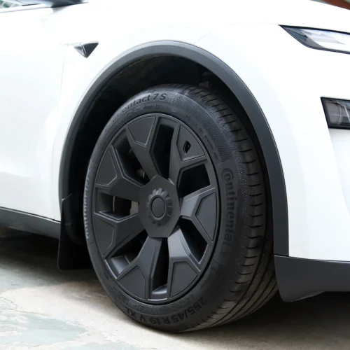 Close-up of a white car's front wheel with a dark gray alloy rim and a Continental tire brand visible on the sidewall of the tire.