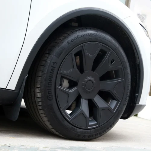 Close-up of a white car's front wheel with a black rim and Continental EcoContact 7S tire.